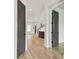 Hallway and open floor plan with wood-look floors, gray doors, and staircase in the background at 441 42Nd Ne Ave, St Petersburg, FL 33703