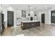 Modern kitchen featuring stainless steel appliances, white cabinets, and a large center island at 441 42Nd Ne Ave, St Petersburg, FL 33703