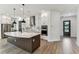 Modern kitchen featuring stainless steel appliances, white cabinets, and a large center island at 441 42Nd Ne Ave, St Petersburg, FL 33703