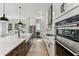 Gourmet kitchen featuring stainless steel appliances, a wine cooler, and a large farmhouse sink at 441 42Nd Ne Ave, St Petersburg, FL 33703