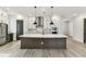 Modern kitchen featuring stainless steel appliances, a large island, and stylish pendant lighting at 441 42Nd Ne Ave, St Petersburg, FL 33703
