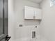Laundry room with overhead cabinets, utility sink and sleek marble tile flooring at 441 42Nd Ne Ave, St Petersburg, FL 33703