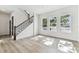 Bright living room features light wood flooring, staircase, and three windows letting in natural light at 441 42Nd Ne Ave, St Petersburg, FL 33703