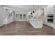 Open-concept living space showcasing hardwood floors, a modern kitchen, and abundant natural light at 441 42Nd Ne Ave, St Petersburg, FL 33703
