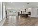 Bright, open-concept living area with wood-look floors, large windows, and an open flow to the kitchen at 441 42Nd Ne Ave, St Petersburg, FL 33703