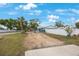 Open backyard with a full fence for privacy, gravel area, and a concrete driveway at 4701 Lodestone Dr, Tampa, FL 33615