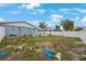 Backyard with a partial view of the house, surrounded by a white vinyl fence at 4701 Lodestone Dr, Tampa, FL 33615