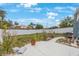 Backyard features a concrete patio area, framed by a white vinyl fence at 4701 Lodestone Dr, Tampa, FL 33615