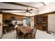 Inviting dining area with wood table, beams, tiled floor, and convenient desk, offering a cozy and functional space at 4701 Lodestone Dr, Tampa, FL 33615
