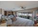Expansive living room featuring a brick fireplace and access to a screened in lanai at 4701 Lodestone Dr, Tampa, FL 33615
