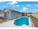 Inviting backyard featuring a sparkling pool and screened-in lanai for outdoor relaxation and entertainment at 4701 Lodestone Dr, Tampa, FL 33615