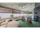 Relaxing sunroom with comfortable seating, strung lights, ceiling fan, and pool views at 4701 Lodestone Dr, Tampa, FL 33615
