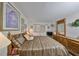 Comfortable bedroom with a wooden bed frame, dresser, and soft lighting, creating a relaxing retreat at 5557 Baywater Dr, Tampa, FL 33615