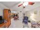Open-concept living area with a view of the kitchen, featuring tile floors and a cozy seating arrangement at 5557 Baywater Dr, Tampa, FL 33615