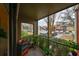 Cozy screened-in patio with plants overlooks the community parking and landscaping at 5557 Baywater Dr, Tampa, FL 33615