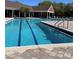 A community swimming pool with clear blue water and lounge chairs, perfect for relaxing and enjoying the outdoors at 5557 Baywater Dr, Tampa, FL 33615