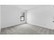 Spacious bedroom with a neutral carpet, light walls, and a bright window at 5710 Humkey St, North Port, FL 34291