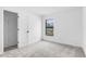 Clean bedroom with a window, plush carpet, and walk-in closet at 5710 Humkey St, North Port, FL 34291