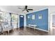 Bright living room with blue accent wall, ceiling fan, and hardwood floors at 7234 12Th N St, St Petersburg, FL 33702