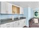 Living room built-in featuring white cabinets, granite countertops, and an attractive starfish decorative object at 7234 12Th N St, St Petersburg, FL 33702