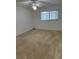 Bedroom featuring a ceiling fan, neutral carpet, and a window providing natural light at 3115 Mission Grove Dr, Palm Harbor, FL 34684