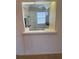 View of the kitchen from the living room featuring white appliances and cabinetry at 3115 Mission Grove Dr, Palm Harbor, FL 34684