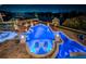Aerial view of a luxury home with a pool, spa, and waterfront access at night at 335 Bath Club S Blvd, North Redington Beach, FL 33708