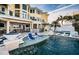 Inviting backyard with a luxurious pool, sun loungers, and lush tropical landscaping at 335 Bath Club S Blvd, North Redington Beach, FL 33708