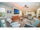 Inviting living room with comfortable seating, modern fireplace and entertainment center at 335 Bath Club S Blvd, North Redington Beach, FL 33708