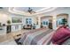 Spacious main bedroom featuring tray ceiling, waterfront views, and sitting area at 335 Bath Club S Blvd, North Redington Beach, FL 33708