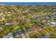 Aerial view of the neighborhood, showcasing its proximity to the coast and featuring lush trees and a mix of homes at 4210 Harrisburg Ne St, St Petersburg, FL 33703