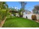 Beautiful backyard showcasing artificial grass, a pergola, and tropical landscaping at 4210 Harrisburg Ne St, St Petersburg, FL 33703