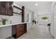 Built-in bar with wine rack, cabinet, and shelving near a living room with fireplace at 4210 Harrisburg Ne St, St Petersburg, FL 33703