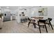 Open floorplan: dining area adjoins a contemporary kitchen with a cozy breakfast bar at 4210 Harrisburg Ne St, St Petersburg, FL 33703