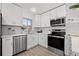 Bright kitchen with stainless steel appliances, white cabinets and quartz countertops at 4210 Harrisburg Ne St, St Petersburg, FL 33703