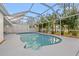 Backyard pool featuring a screened enclosure, surrounding landscaping and a privacy fence at 4210 Harrisburg Ne St, St Petersburg, FL 33703