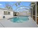 Backyard pool with a screened enclosure featuring outdoor furniture and a white privacy fence at 4210 Harrisburg Ne St, St Petersburg, FL 33703