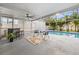 Screened pool area featuring outdoor furniture, privacy curtains and tropical landscaping at 4210 Harrisburg Ne St, St Petersburg, FL 33703