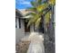 Inviting entrance with tiled walkway, privacy gate and lush tropical landscaping at 439 Boca Ciega Point N Blvd, St Petersburg, FL 33708