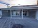 Covered patio with ceiling fans, tiled floors and sliding glass doors offering serene water views at 439 Boca Ciega Point N Blvd, St Petersburg, FL 33708