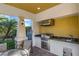 Outdoor kitchen featuring a stainless steel grill, sink, granite countertop, and stone accents at 5811 Arbor Wood Ct, Bradenton, FL 34203