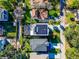 Aerial view of a modern home with a pool, solar panels, and well-maintained landscaping at 818 W Adalee St, Tampa, FL 33603