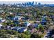 Aerial view of a residential neighborhood featuring houses, trees, and city skyline in background at 818 W Adalee St, Tampa, FL 33603