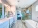 Beautiful bathroom with a soaking tub, glass shower, double sinks, and stylish tile work at 818 W Adalee St, Tampa, FL 33603