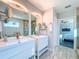 Elegant bathroom featuring double vanity sinks, large mirrors, and modern fixtures at 818 W Adalee St, Tampa, FL 33603
