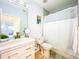Well-lit bathroom with a single vanity, toilet, shower/tub combo, and classic fixtures at 818 W Adalee St, Tampa, FL 33603