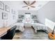 Cozy bedroom with twin beds, hardwood floors, bright window, and decorative wall art at 818 W Adalee St, Tampa, FL 33603