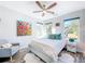 Cozy bedroom featuring a comfortable bed, bright art and hardwood flooring at 818 W Adalee St, Tampa, FL 33603