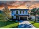 Contemporary two-story home with modern architecture, a manicured lawn, and stylish brick driveway at 818 W Adalee St, Tampa, FL 33603
