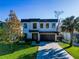 Contemporary two-story home with modern design, landscaped yard, and a two car garage at 818 W Adalee St, Tampa, FL 33603